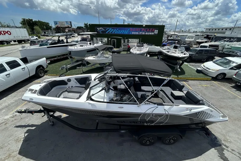 Slide: The Image of 2023 Scarab 255 ID boat with black canopy, displayed at Miami Boat Place. - 55