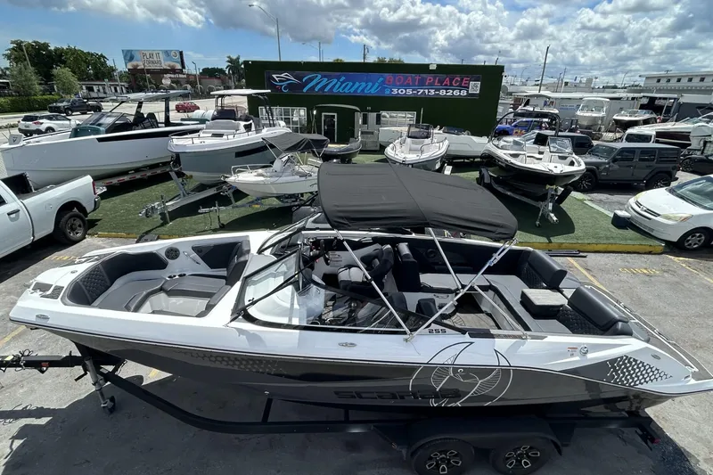 Slide: The Image of 2023 Scarab 255 ID boat displayed at Miami Boat Place under a cloudy sky. - 56