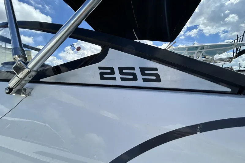 Slide: The Image of 2023 Scarab 255 ID boat detail with clear sky background. - 6