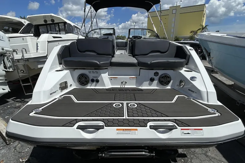 Slide: The Image of 2023 Scarab 255 ID boat with sleek design and comfortable seating, docked under a sunny sky. - 8