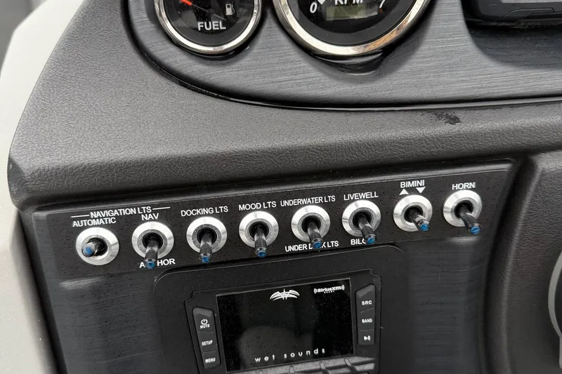 Slide: The Image of Control panel of 2025 Berkshire 22RFX CTS boat with various switches and gauges. - 13