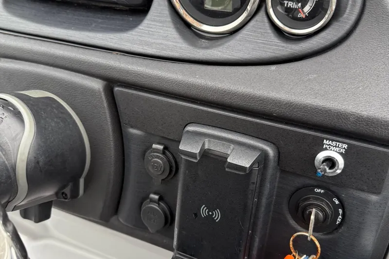 Slide: The Image of Dashboard controls of a 2025 Berkshire 22RFX CTS boat with power switches and gauges. - 14