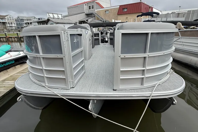 Slide: The Image of 2025 Berkshire 22RFX CTS pontoon boat, saltwater edition, parked on asphalt. - 2