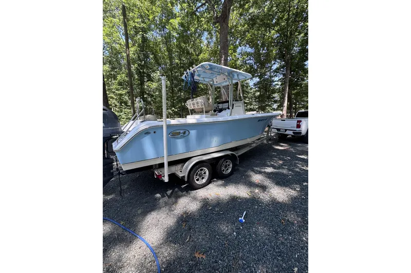 Slide: The Image of 2018 Sea Hunt Ultra 234 boat on calm water with Yamaha outboard motor. - 1