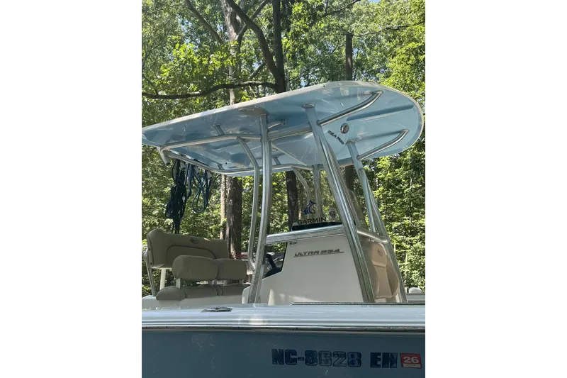 Slide: The Image of 2018 Sea Hunt Ultra 234 boat on water, featuring Yamaha outboard motor. - 2