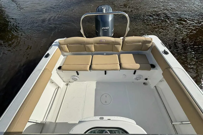 Slide: The Image of 2018 Sea Hunt Ultra 234 boat interior with tan seating and Yamaha 200 engine. - 20