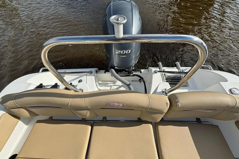 Slide: The Image of 2018 Sea Hunt Ultra 234 boat with Yamaha 200 engine, beige seating, and stainless steel rail. - 23