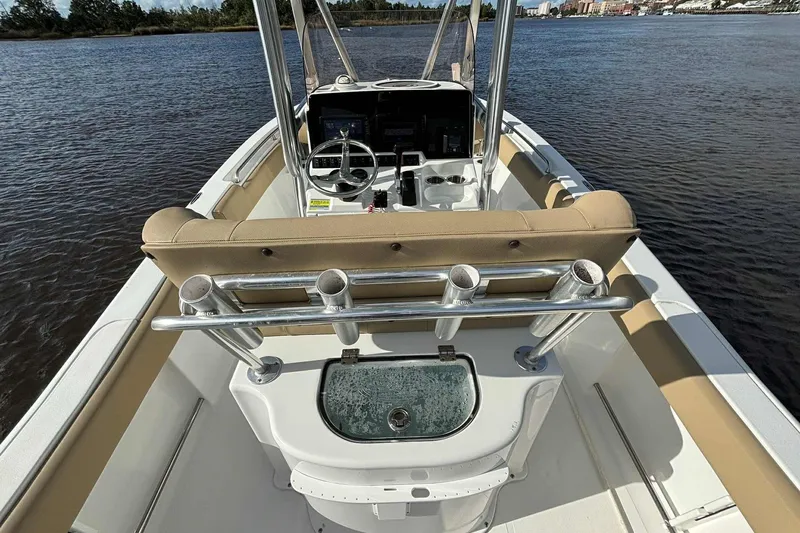 Slide: The Image of 2018 Sea Hunt Ultra 234 boat interior with steering console and rod holders. - 24