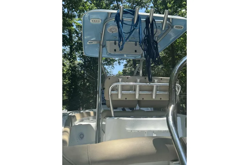 Slide: The Image of 2018 Sea Hunt Ultra 234 boat cruising on a calm river with lush green trees. - 6