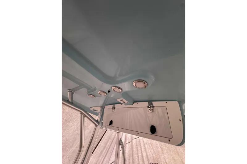 Slide: The Image of 2018 Sea Hunt Ultra 234 boat on water, with Yamaha engine, surrounded by trees. - 8