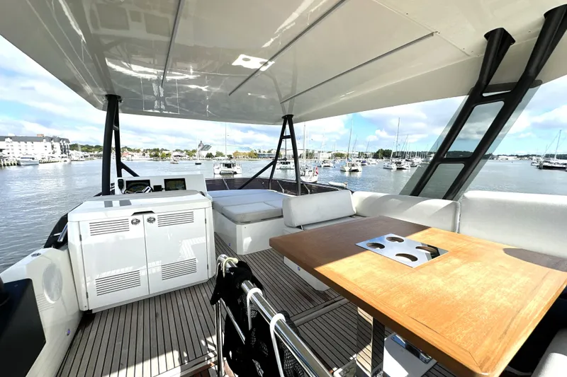 Slide: The Image of Luxurious 2023 Prestige 520 yacht interior with elegant seating and scenic marina view. - 17