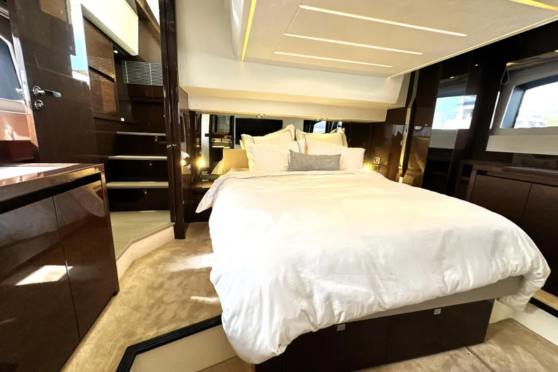 Slide: The Image of Luxurious bedroom interior of 2023 Prestige 520 yacht with elegant bedding and modern design. - 2