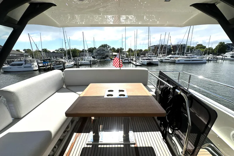 Slide: The Image of Luxurious 2023 Prestige 520 yacht interior with marina view, featuring elegant seating and table. - 20
