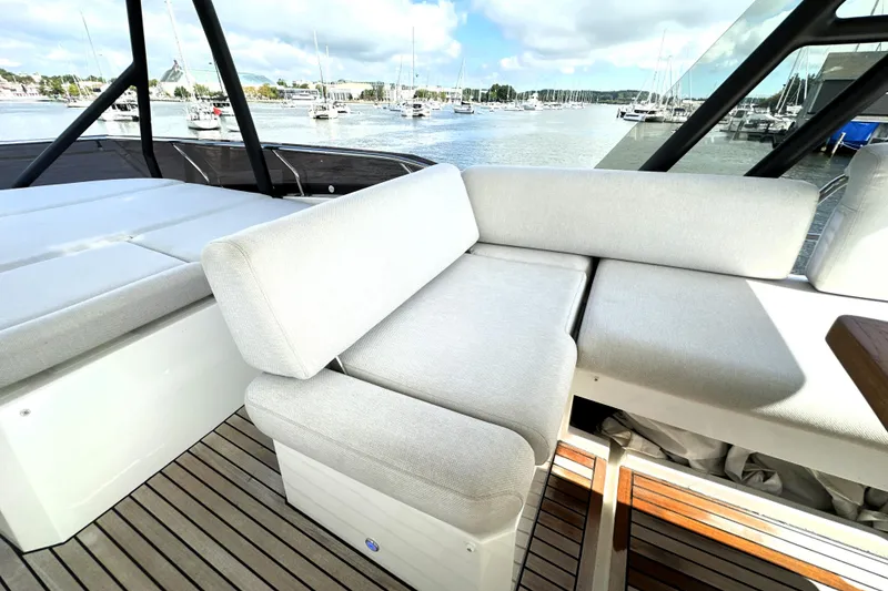 Slide: The Image of Luxurious seating on 2023 Prestige 520 yacht with scenic marina view. - 21