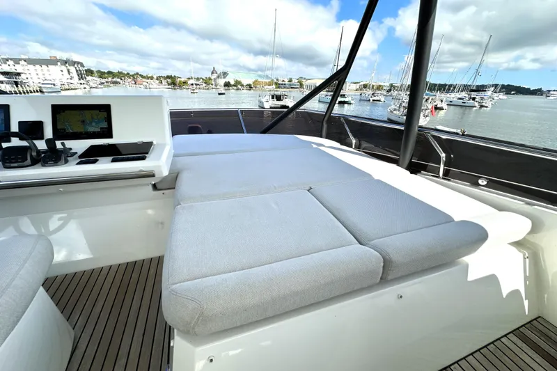 Slide: The Image of Luxurious 2023 Prestige 520 yacht interior with plush seating and modern navigation equipment. - 23