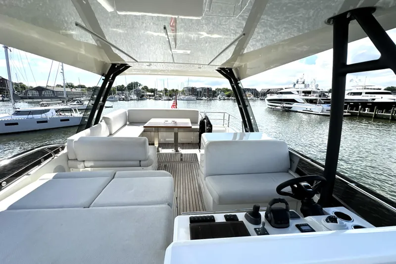 Slide: The Image of Luxurious 2023 Prestige 520 yacht interior with spacious seating and scenic marina view. - 3