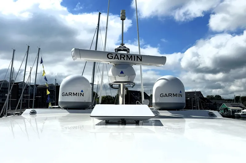 Slide: The Image of 2023 Prestige 520 yacht with Garmin radar and antennas under a cloudy sky. - 32