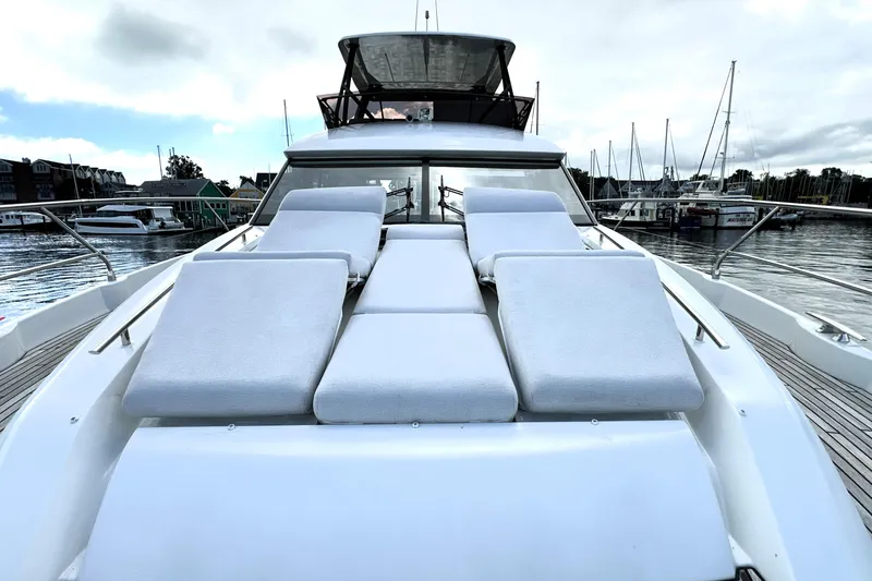 Slide: The Image of Luxurious 2023 Prestige 520 yacht with sun loungers, docked at a marina. - 35