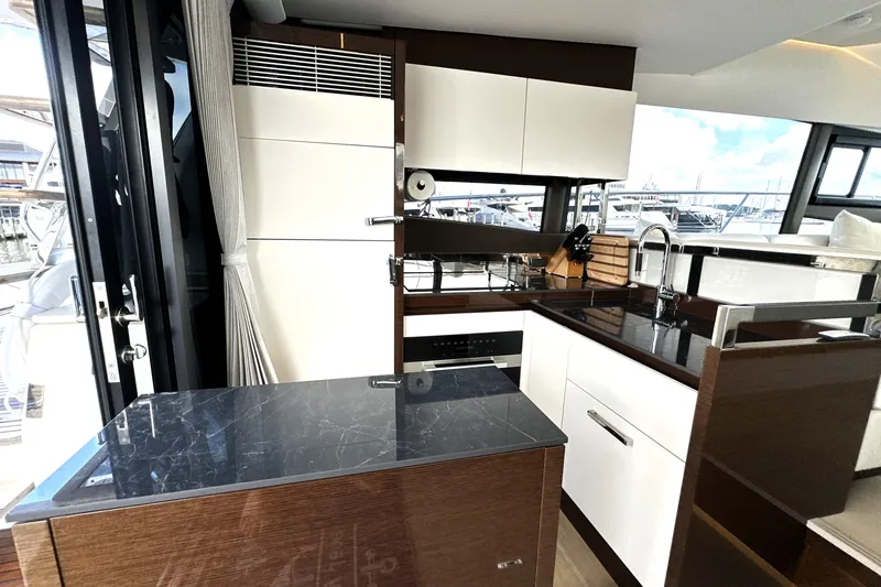Slide: The Image of Modern kitchen interior on 2023 Prestige 520 yacht, featuring sleek cabinetry and appliances. - 41