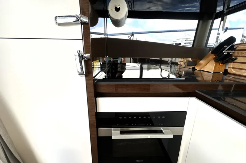 Slide: The Image of Modern kitchen interior on 2023 Prestige 520 yacht, featuring sleek appliances and elegant design. - 42