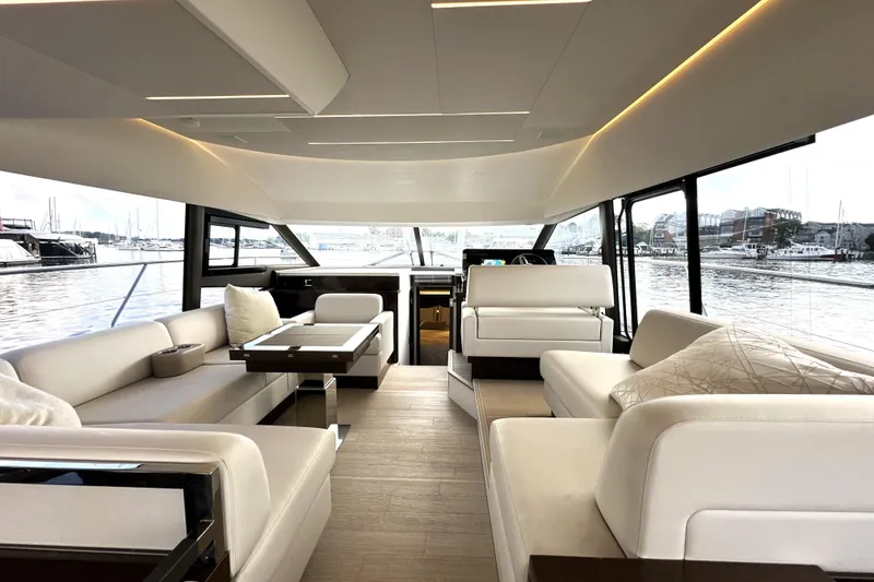 Slide: The Image of Luxurious interior of 2023 Prestige 520 yacht with elegant seating and panoramic windows. - 44