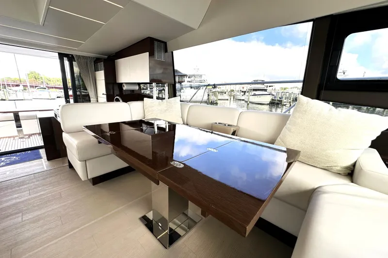 Slide: The Image of Luxurious interior of 2023 Prestige 520 yacht with elegant seating and glossy table. - 46