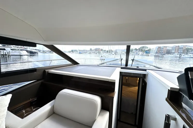 Slide: The Image of Interior view of 2023 Prestige 520 yacht with marina backdrop. - 47