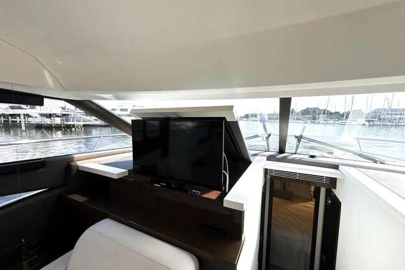 Slide: The Image of Luxurious interior of 2023 Prestige 520 yacht with TV and waterfront view. - 48