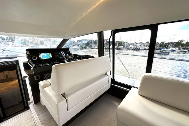 Slide: The Image of Luxurious interior of 2023 Prestige 520 yacht with modern helm and marina view. - 49