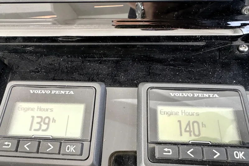 Slide: The Image of Volvo Penta engine hour meters displaying 139 and 140 hours on a 2023 Prestige 520. - 56
