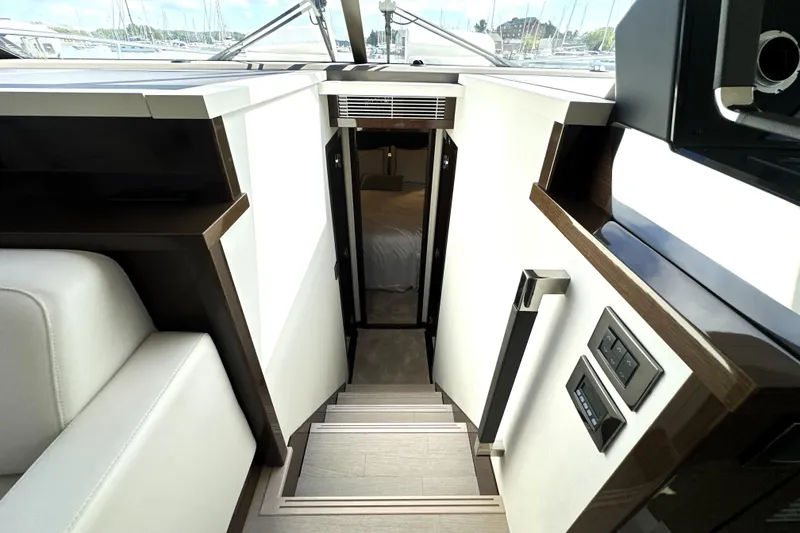 Slide: The Image of Stairway leading to cabin interior of 2023 Prestige 520 yacht, featuring modern design elements. - 57