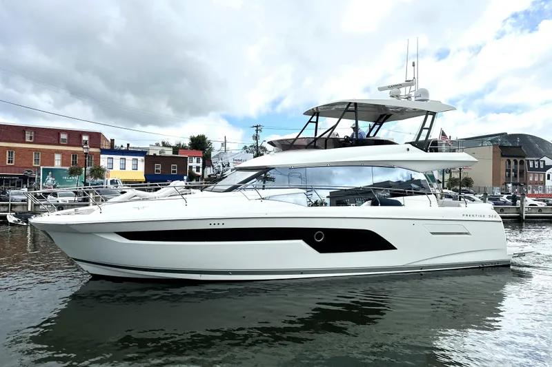 Slide: The Image of 2023 Prestige 520 yacht docked in a marina, showcasing sleek design and modern features. - 6
