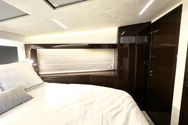 Slide: The Image of Luxurious interior of 2023 Prestige 520 yacht bedroom with modern design and ambient lighting. - 60