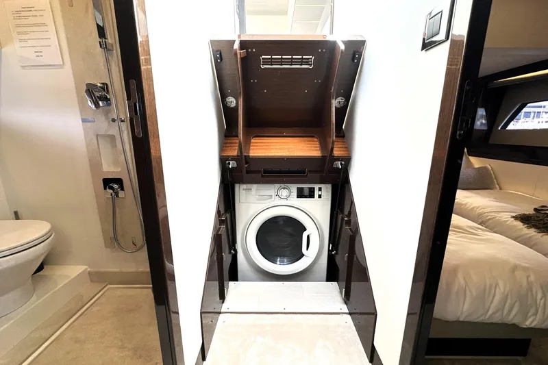 Slide: The Image of 2023 Prestige 520 yacht interior with washing machine, bathroom, and bedroom. - 65