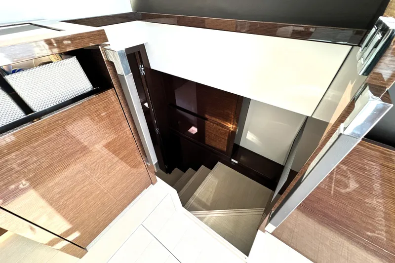 Slide: The Image of Staircase in 2023 Prestige 520 yacht, featuring sleek wood and modern design elements. - 66