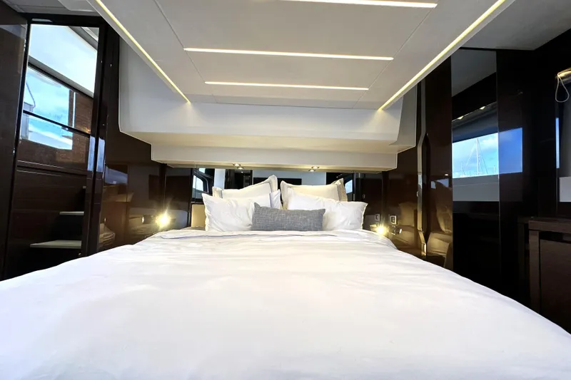 Slide: The Image of Luxurious bedroom interior of 2023 Prestige 520 yacht with modern design and ambient lighting. - 69