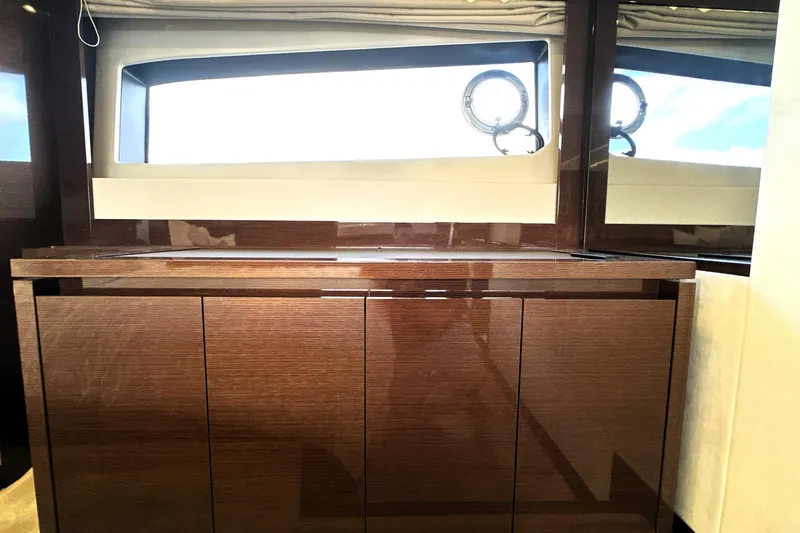 Slide: The Image of Luxurious interior of 2023 Prestige 520 yacht with sleek wooden cabinetry and large windows. - 70