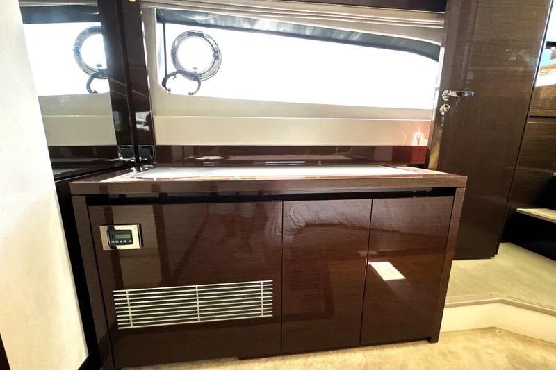Slide: The Image of 2023 Prestige 520 yacht interior with sleek wooden cabinetry and modern design elements. - 72