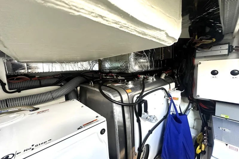 Slide: The Image of Engine room of 2023 Prestige 520 yacht with mechanical components and wiring. - 77