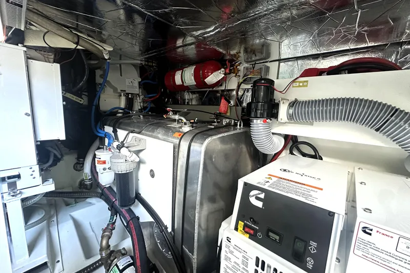 Slide: The Image of Engine room of 2023 Prestige 520 yacht with Cummins generator and fire safety equipment. - 78