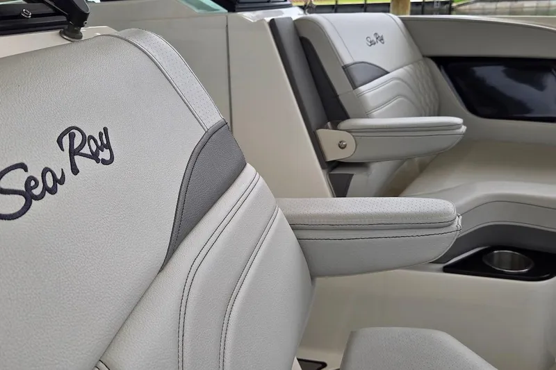 Slide: The Image of 2023 Sea Ray SLX 280 Outboard interior with luxurious seating and armrests. - 10