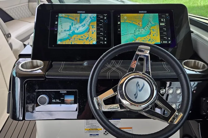 Slide: The Image of 2023 Sea Ray SLX 280 Outboard dashboard with dual Simrad displays and steering wheel. - 13