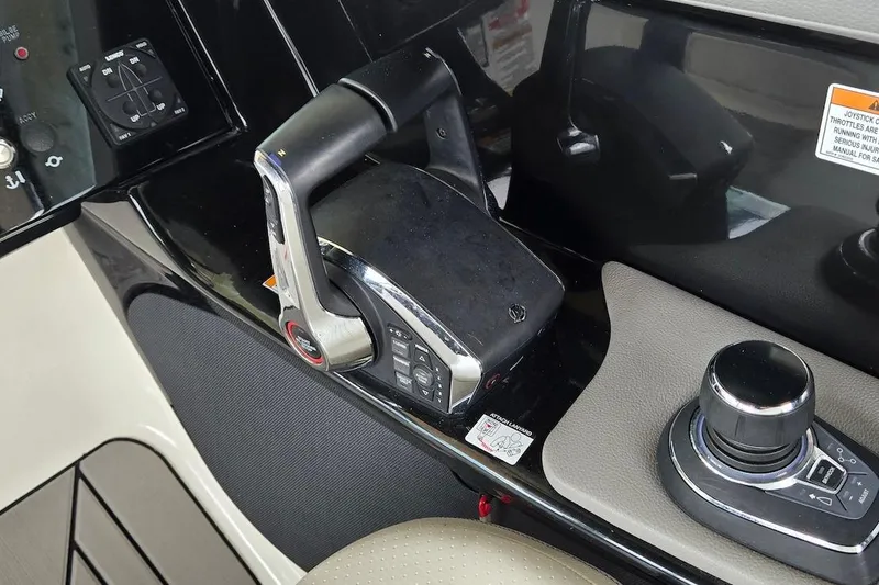 Slide: The Image of Control panel of 2023 Sea Ray SLX 280 Outboard boat, featuring throttle and joystick controls. - 14