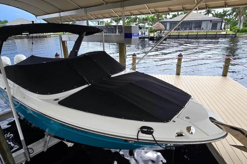 Slide: The Image of 2023 Sea Ray SLX 280 Outboard boat docked under a canopy. - 19