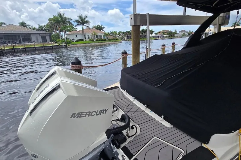Slide: The Image of 2023 Sea Ray SLX 280 Outboard with Mercury engines docked by waterfront homes. - 22