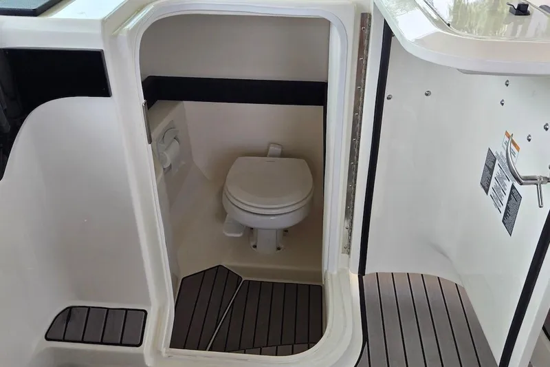 Slide: The Image of 2023 Sea Ray SLX 280 Outboard boat interior with compact marine toilet. - 27