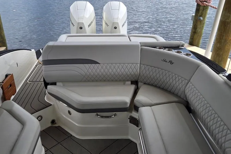 Slide: The Image of 2023 Sea Ray SLX 280 Outboard boat interior with luxurious seating and dual Mercury engines. - 6