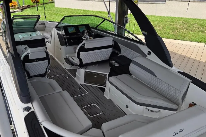 Slide: The Image of 2023 Sea Ray SLX 280 Outboard interior with luxurious seating and modern dashboard. - 7