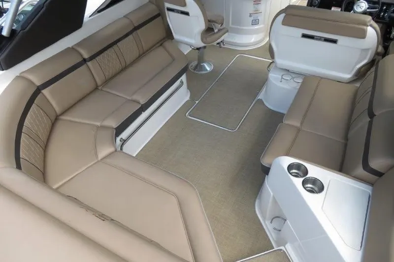 Slide: The Image of Interior of a 2016 Sea Ray 280 SLX boat with beige seating and cup holders. - 3