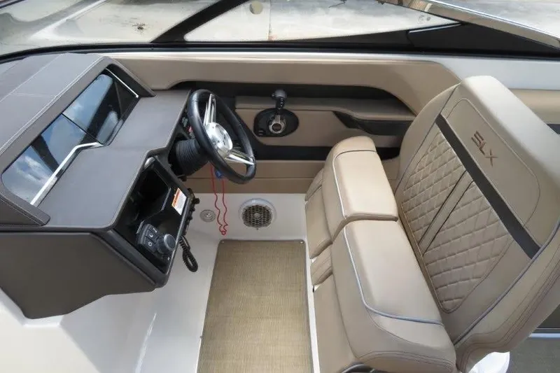 Slide: The Image of Interior of 2016 Sea Ray 280 SLX boat with steering wheel and beige seating. - 4
